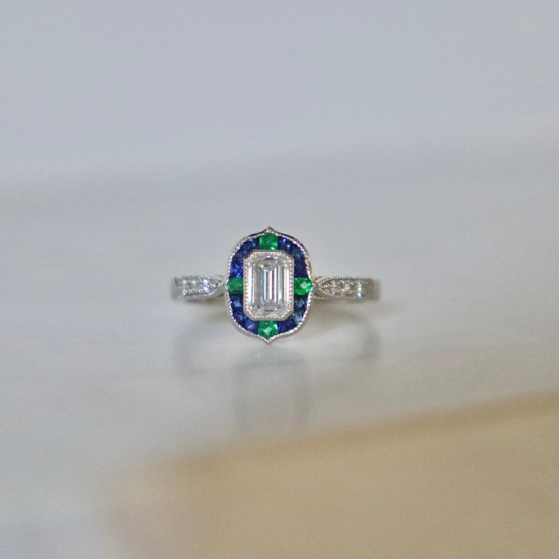 Platinum Emerald Cut Diamond with Sapphire and Emerald Art Deco Style Halo