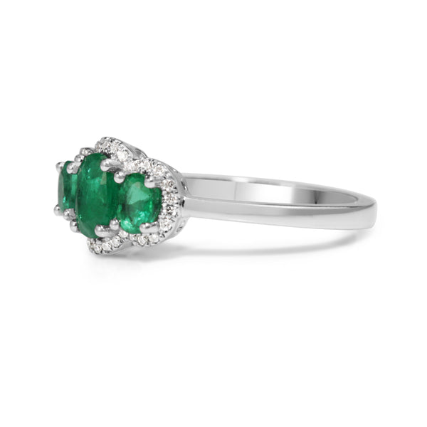 18ct White Gold 3 Stone Emerald and Diamond Halo Ring