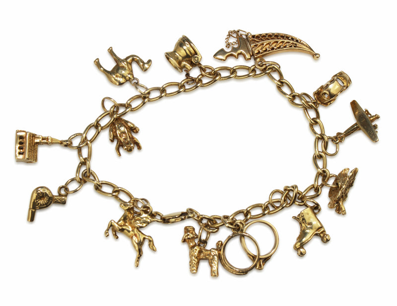 Lot 76 - 18ct gold charm bracelet with various 18ct,